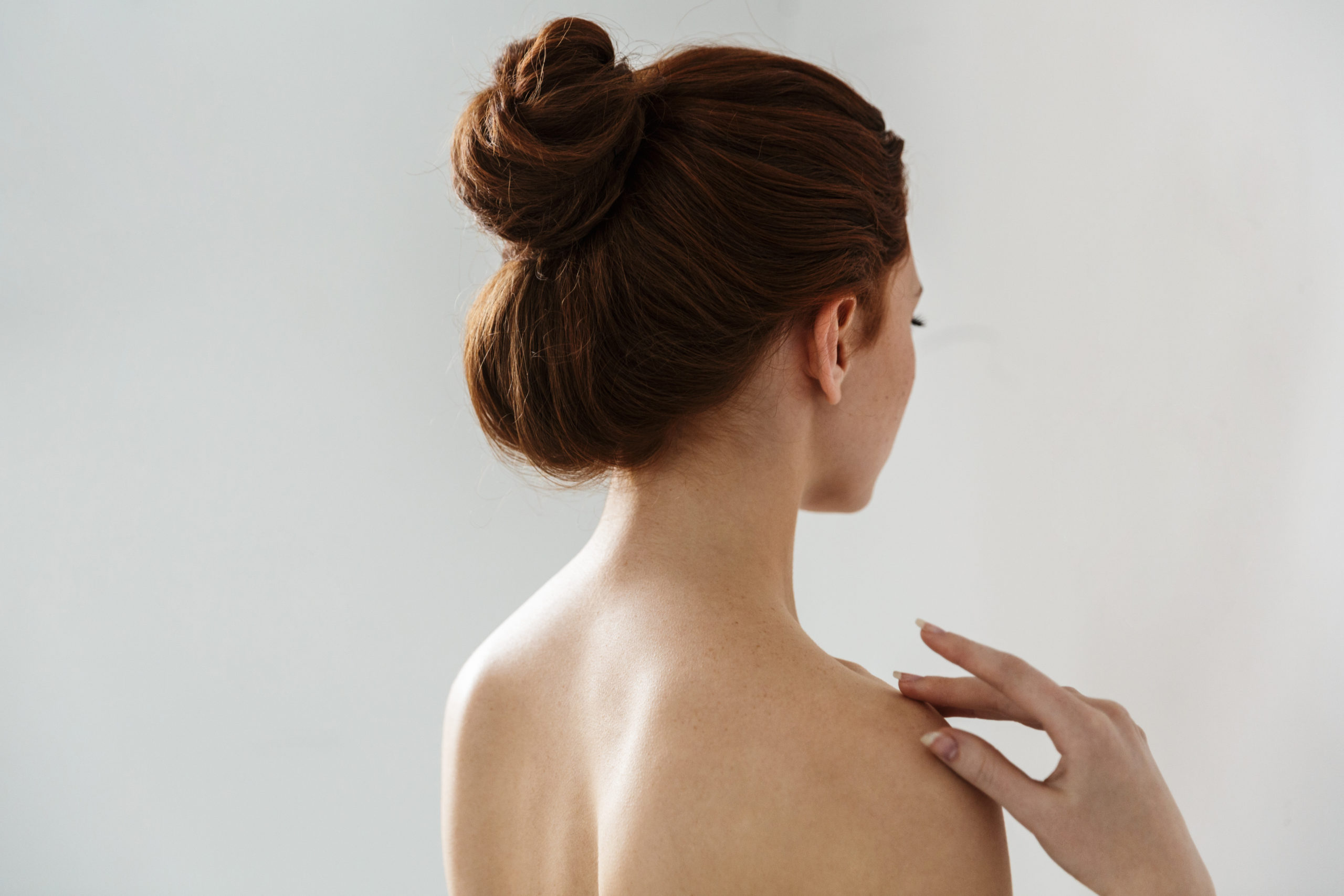 Beauty portrait of an attractive young topless redhead woman