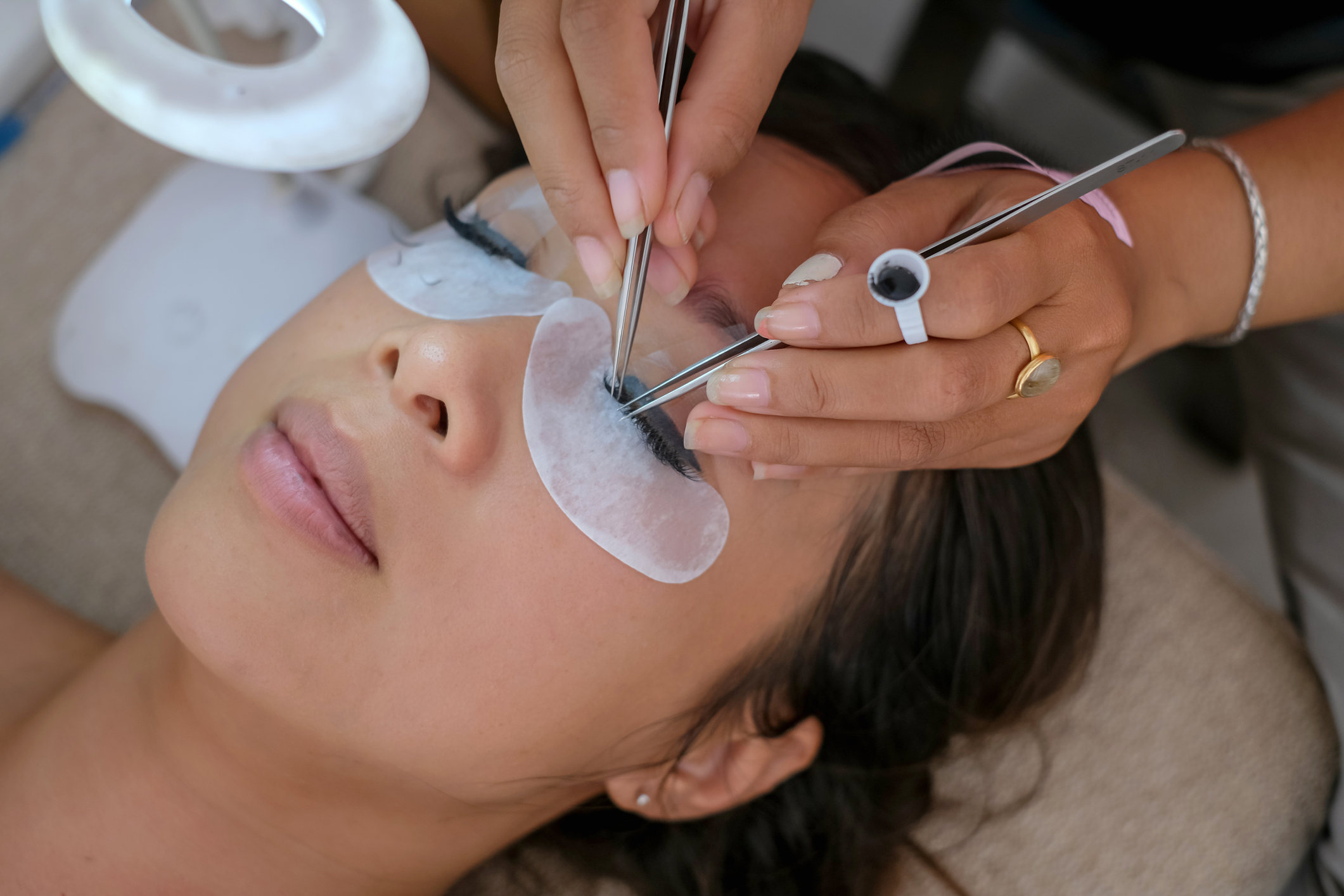 Beautiful Woman Getting Home Service Eyelash Extension