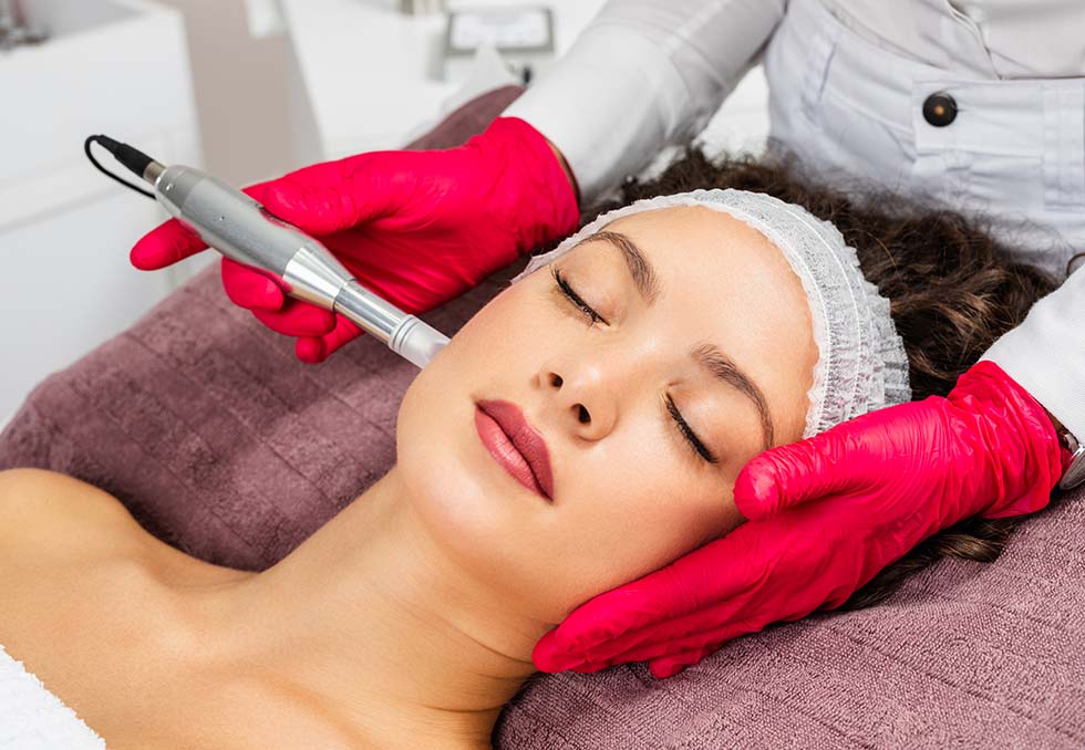 Beautiful woman receiving microneedling rejuvenation treatment.