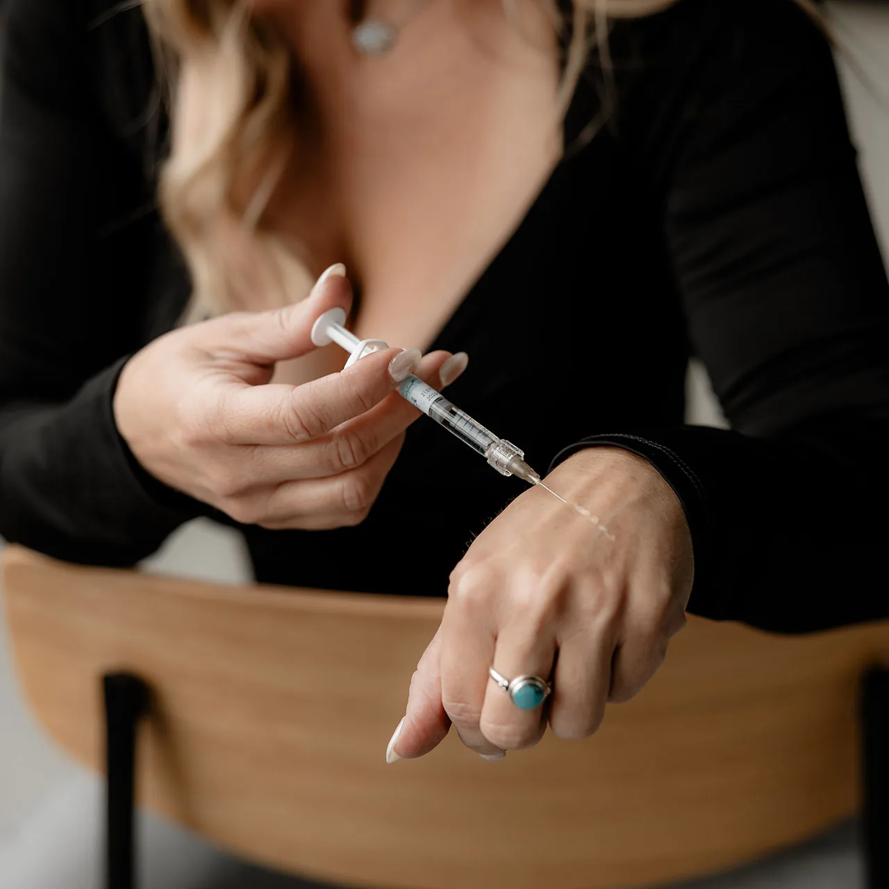Staff holding with syringe Alyssa holding Zo Skin Product